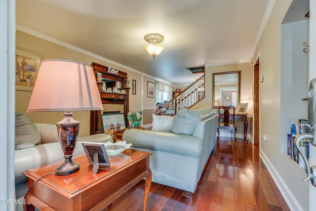 living area with stairs, baseboards, wood finished floors, and crown molding