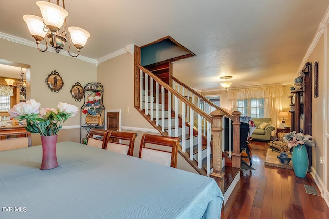 dining area featuring crown molding, stairway, a chandelier, baseboards, and hardwood / wood-style flooring