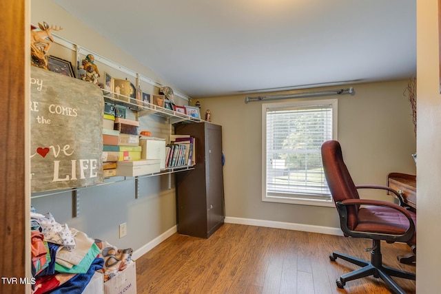 office area with baseboards and wood finished floors