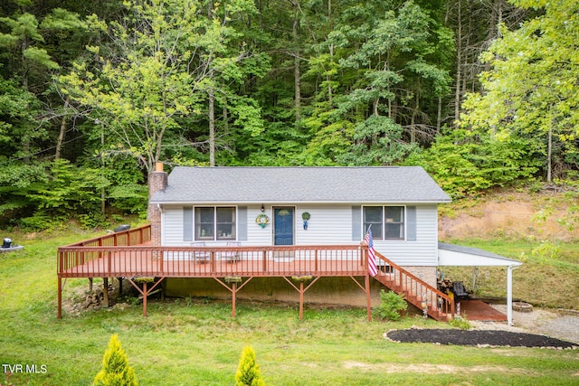 view of front of house with a deck and a front lawn