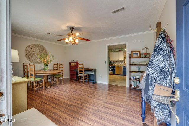 interior space featuring ceiling fan, ornamental molding, and hardwood / wood-style floors