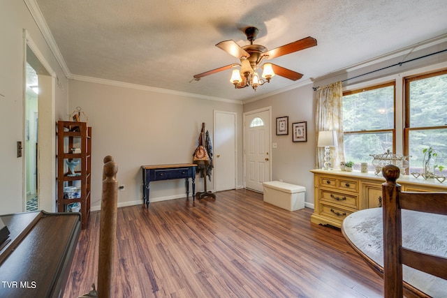 bedroom featuring crown molding, a textured ceiling, dark hardwood / wood-style floors, and ceiling fan