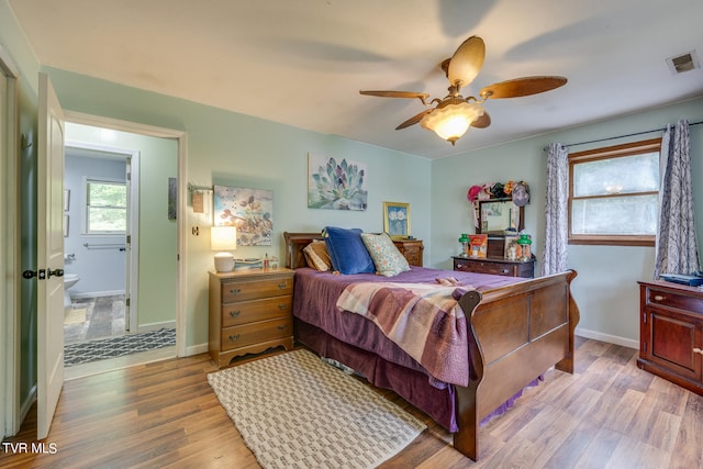 bedroom featuring light hardwood / wood-style flooring, ensuite bathroom, and ceiling fan