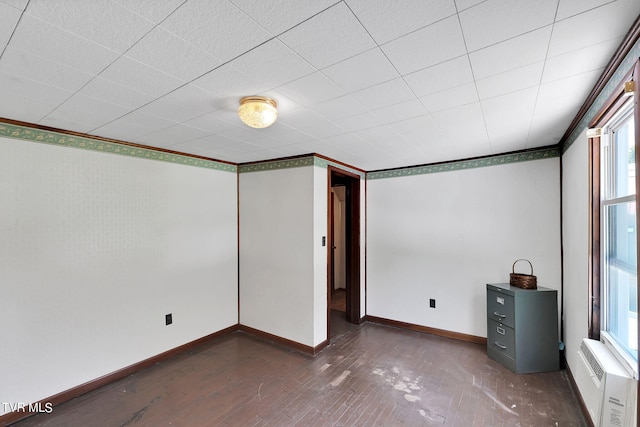 interior space with dark wood-type flooring, a wall mounted air conditioner, and crown molding