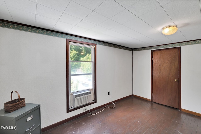 unfurnished bedroom featuring crown molding, cooling unit, and dark hardwood / wood-style flooring