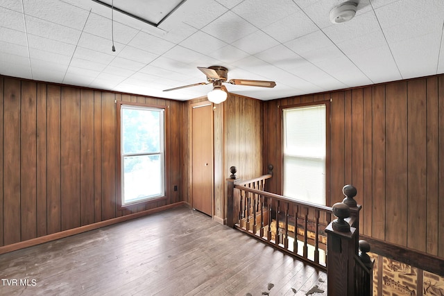 interior space featuring hardwood / wood-style floors and wood walls