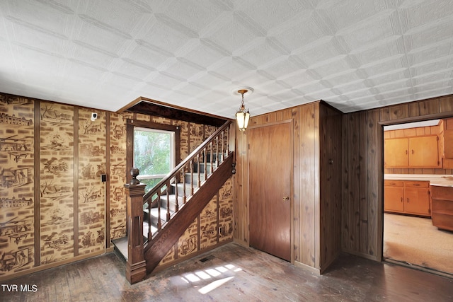 interior space with hardwood / wood-style floors and wood walls