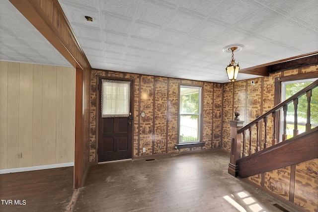 foyer entrance featuring a healthy amount of sunlight and dark wood-type flooring