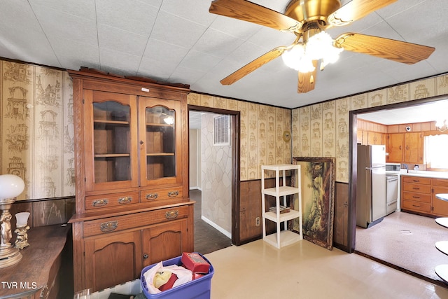 interior space featuring stove, stainless steel fridge, and ceiling fan