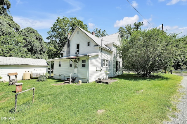 view of side of home featuring a lawn