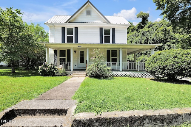 farmhouse with covered porch and a front lawn