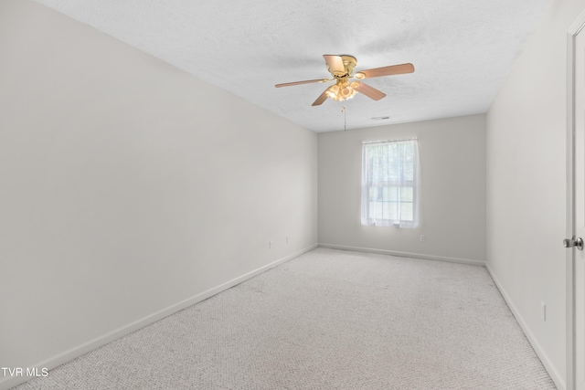 spare room featuring ceiling fan, a textured ceiling, and carpet flooring