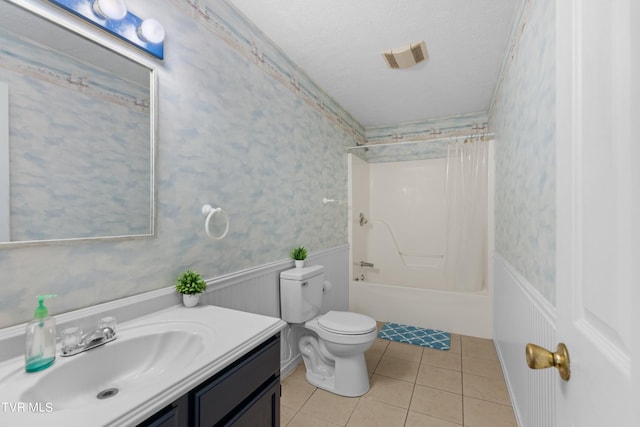 full bathroom with a textured ceiling, toilet, tile patterned flooring, vanity, and bathing tub / shower combination