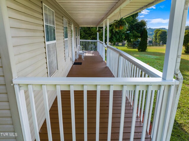 wooden deck featuring a yard