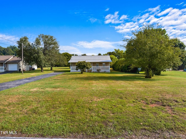 view of front of home with a front yard and a garage