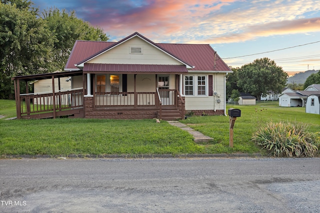 view of front facade with a porch and a yard