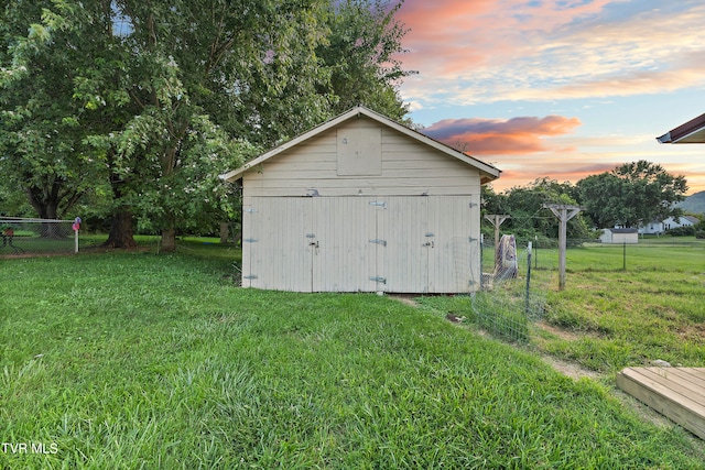 outdoor structure at dusk with a yard