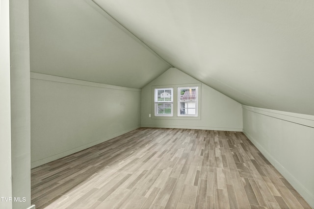 bonus room featuring light hardwood / wood-style flooring and lofted ceiling