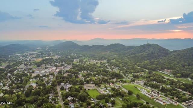 aerial view at dusk featuring a mountain view