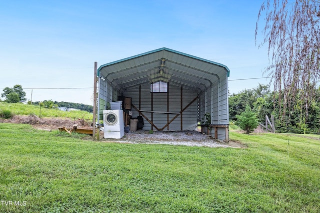 view of outdoor structure with a carport and a lawn