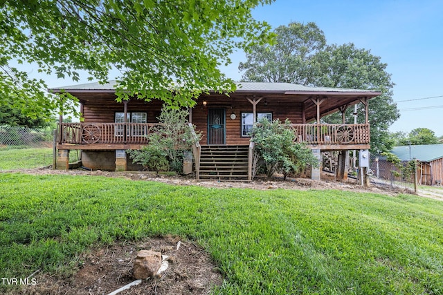 rear view of property featuring a deck and a yard