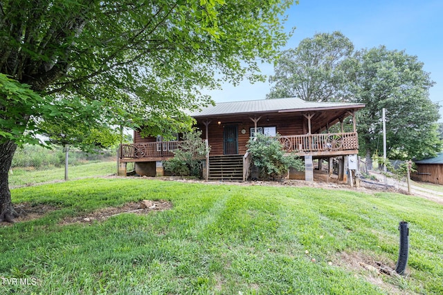 back of house featuring a lawn and a deck