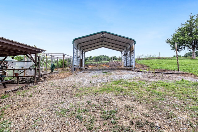 view of outbuilding with a carport and a rural view