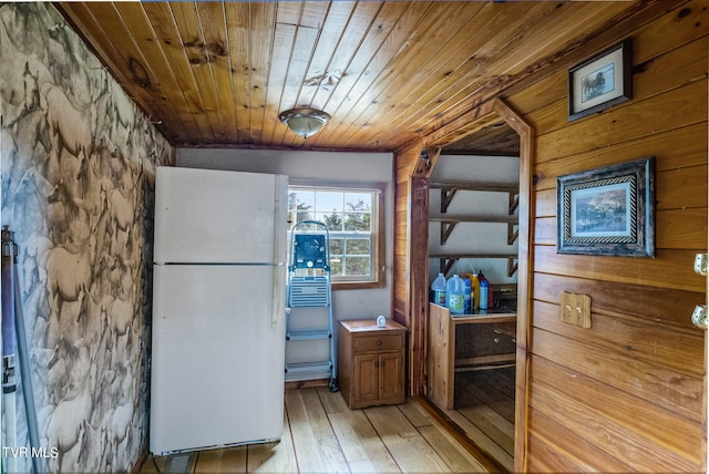 kitchen featuring light wood-type flooring, refrigerator, and wood ceiling