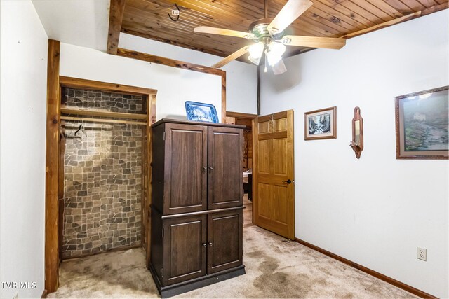 interior space with ceiling fan and wood ceiling