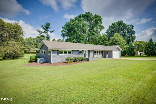 ranch-style home featuring concrete driveway, stone siding, an attached garage, central AC, and a front yard