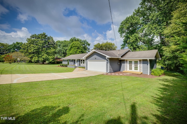 ranch-style house featuring a front lawn and a garage