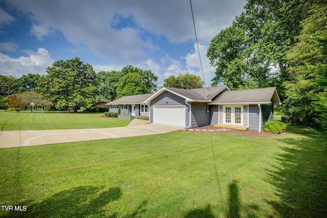 single story home with a garage, a front yard, french doors, and driveway