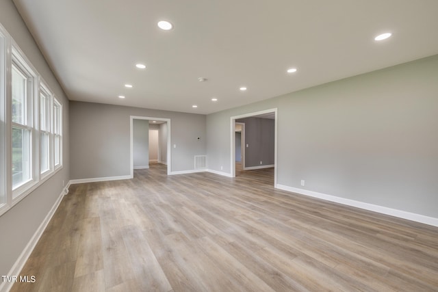 empty room with light hardwood / wood-style flooring