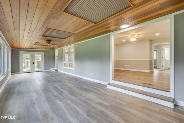 empty room featuring ceiling fan, french doors, hardwood / wood-style floors, and wood ceiling