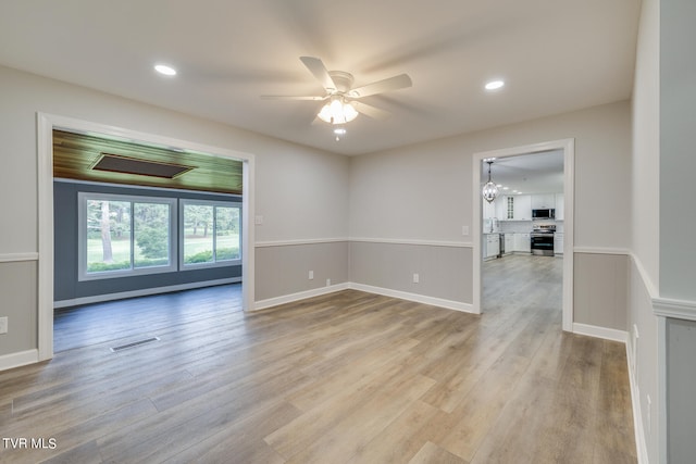 unfurnished room with light wood-type flooring and ceiling fan