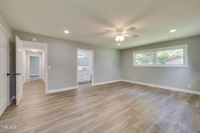 unfurnished bedroom with ceiling fan, ensuite bathroom, and light hardwood / wood-style floors