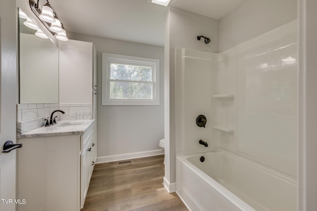 full bathroom with shower / bath combination, toilet, vanity, and wood-type flooring