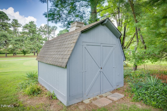 view of outdoor structure featuring a lawn