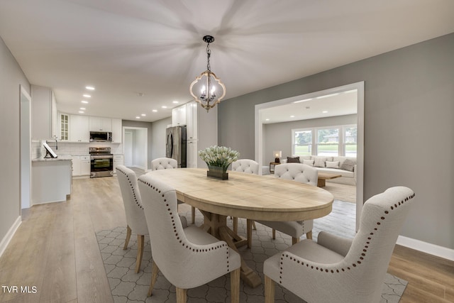 dining room with a notable chandelier and light hardwood / wood-style floors