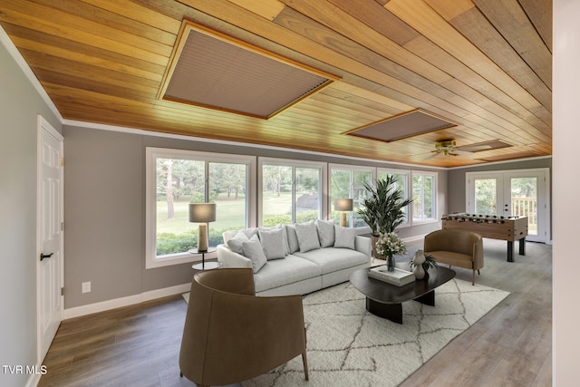 living room featuring hardwood / wood-style floors, ornamental molding, ceiling fan, and wooden ceiling