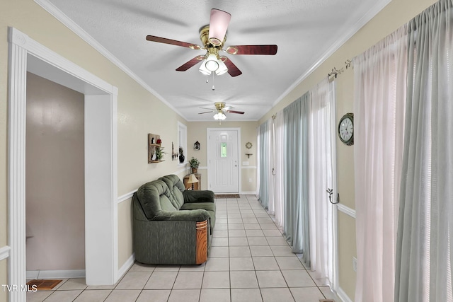 living room featuring crown molding, a textured ceiling, light tile patterned floors, and ceiling fan