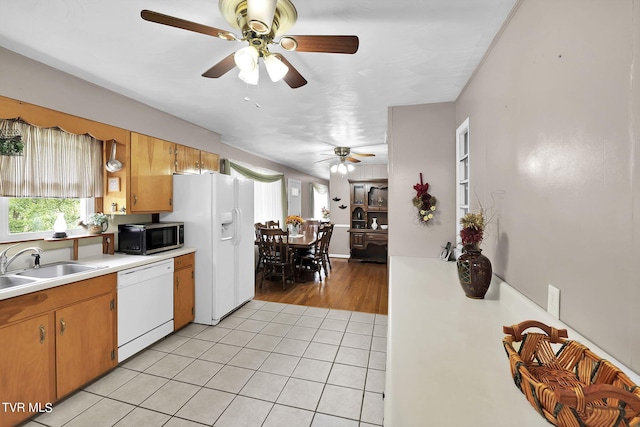 kitchen featuring white appliances, sink, ceiling fan, and light hardwood / wood-style floors