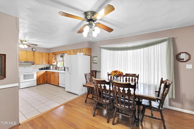 dining space with plenty of natural light, ceiling fan, sink, and light wood-type flooring