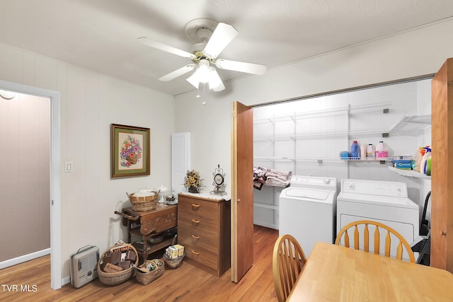 washroom featuring washing machine and clothes dryer, ceiling fan, and light wood-type flooring