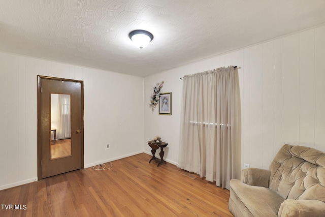 unfurnished room with wood-type flooring and a textured ceiling