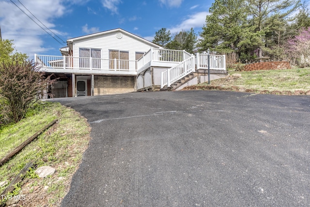 172 Lee Ave, Lebanon, VA 24266 - view of front facade featuring stairway, a deck, a garage, and driveway
