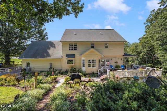 rear view of property featuring a patio and a wooden deck