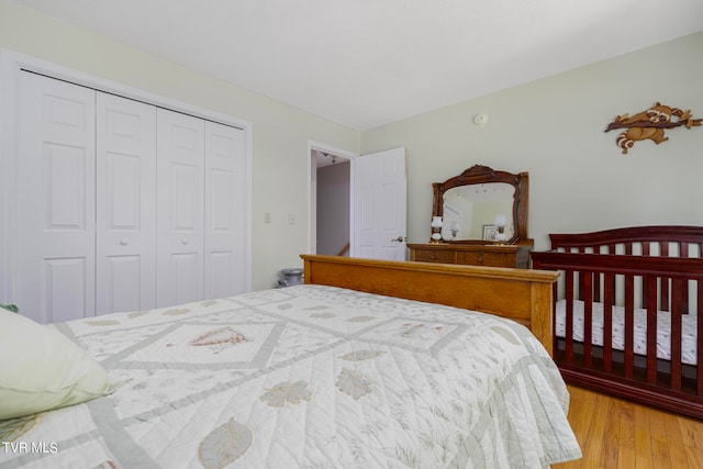 bedroom with light hardwood / wood-style flooring and a closet