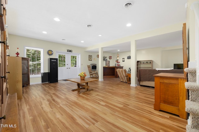 living room with light wood-type flooring and french doors