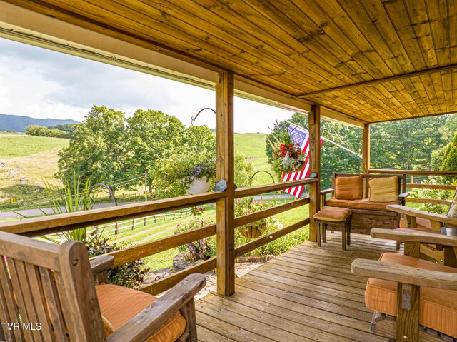 deck featuring a rural view and a mountain view